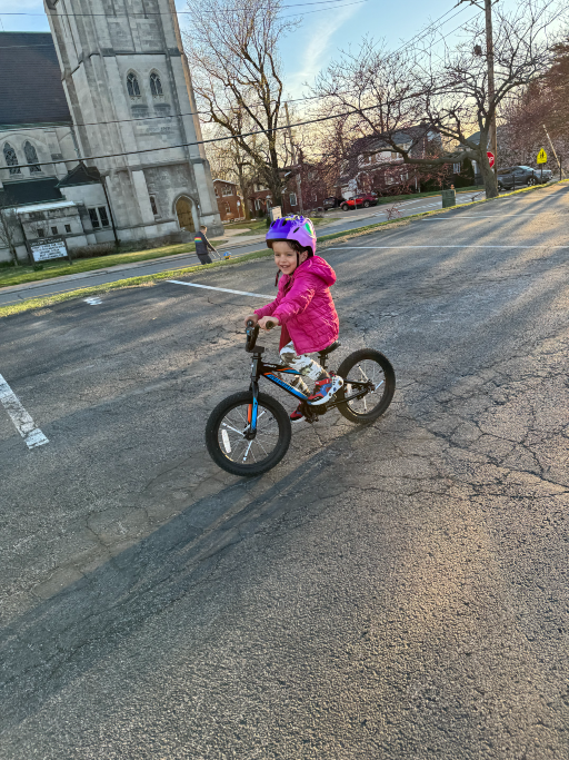 Logan looking pleased with himself as he rides a bike